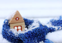 Haus in der Schneelastzone, mit einem wärmenden Schal und Schnee